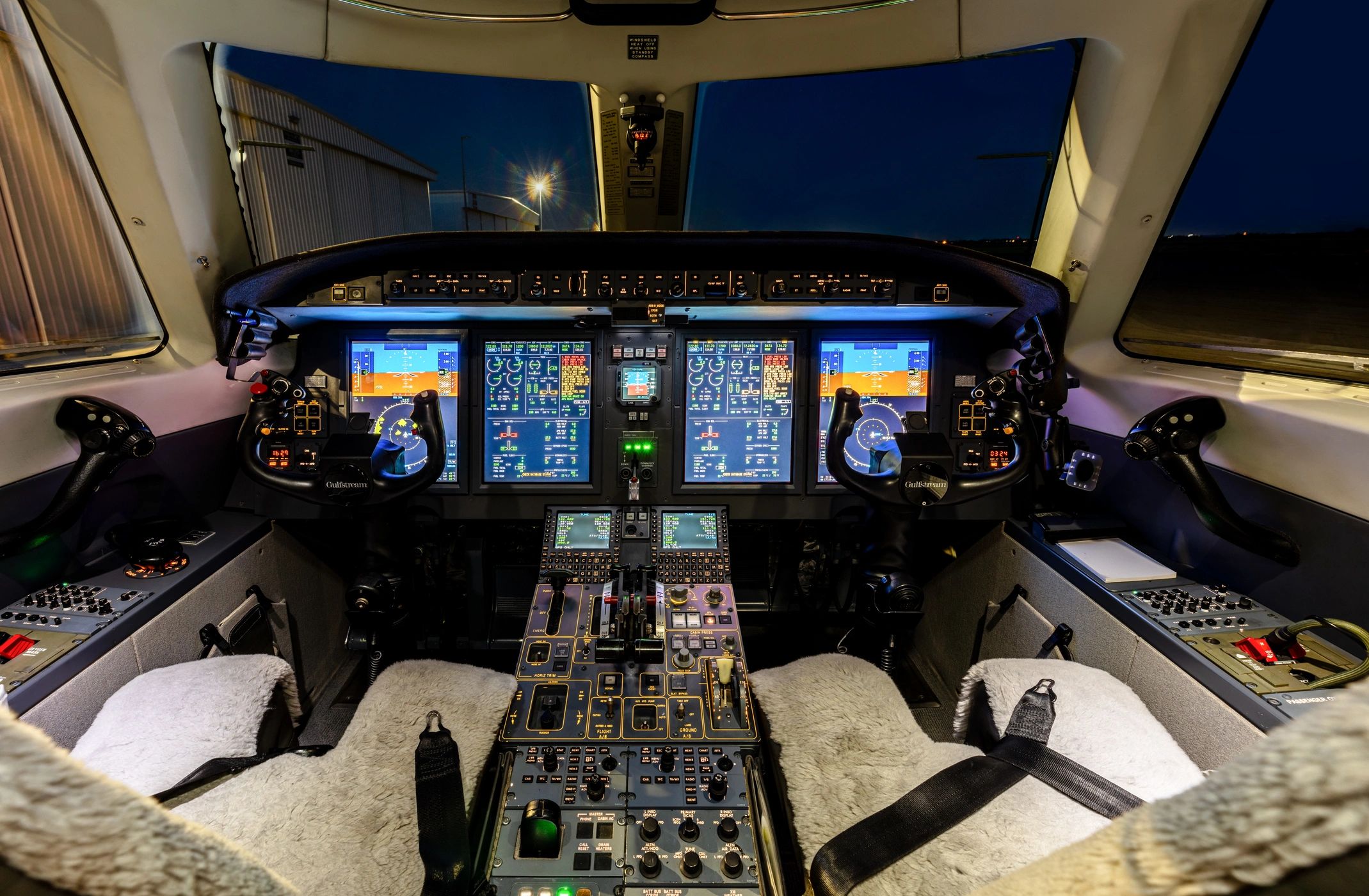 Private jet cockpit with illuminated controls