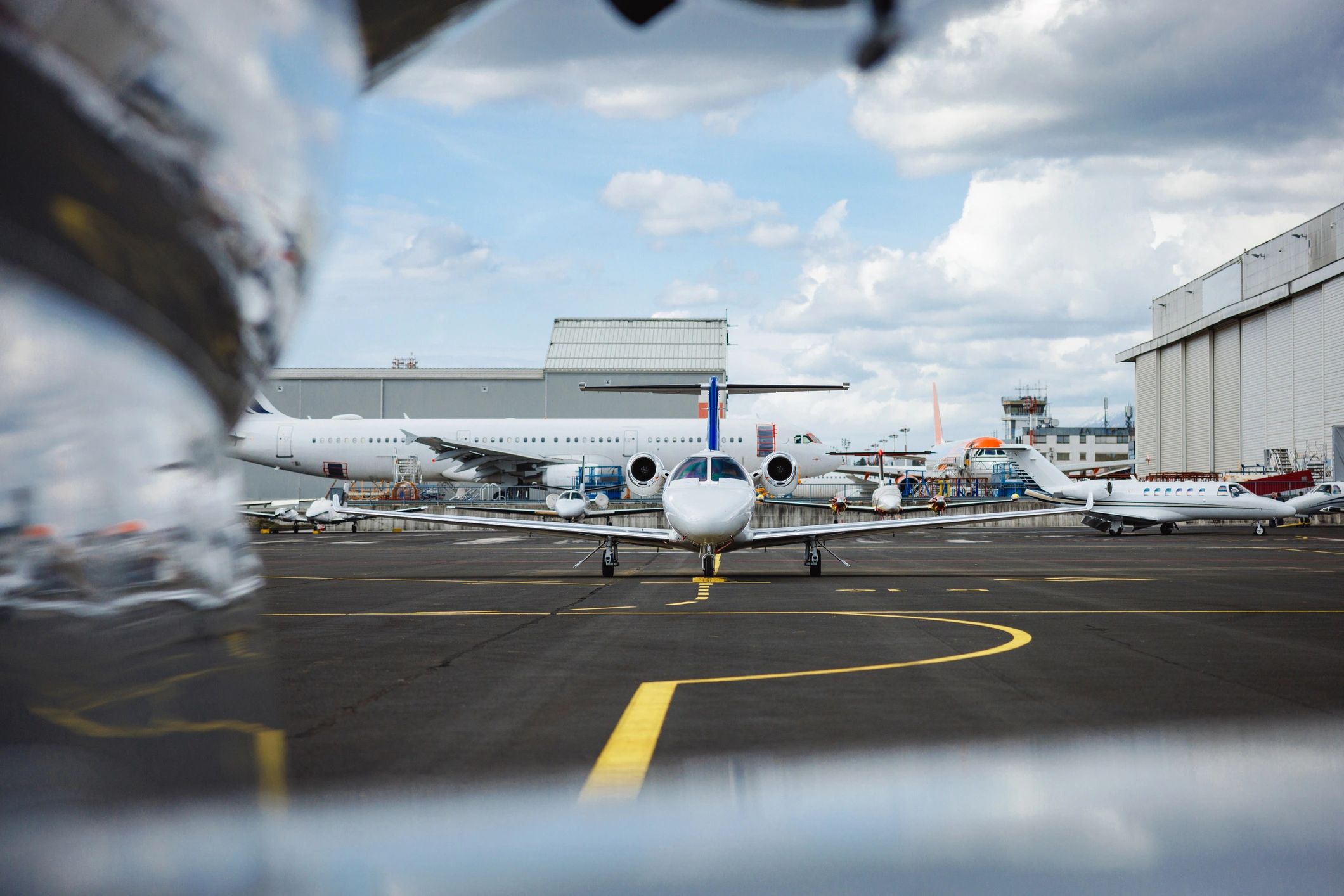 Corporate jets lined up on airport tarmac